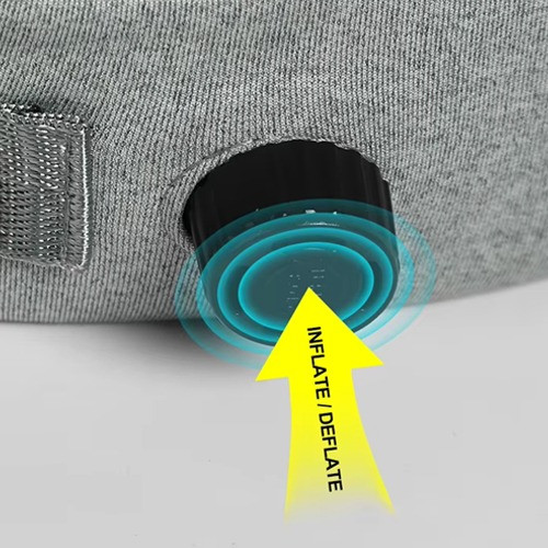 Self-inflating travel neck pillow with press-type inflation button, shown against a white background.