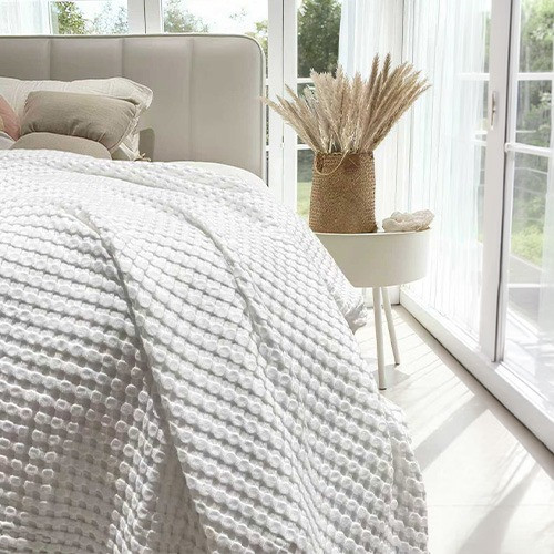 Bambi All Seasons Cotton Bamboo Lightweight Waffle Blanket draped over bed