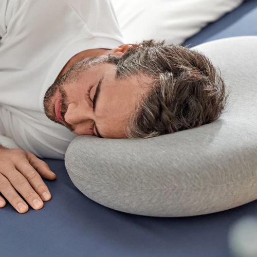 Happy man sleeping in bed