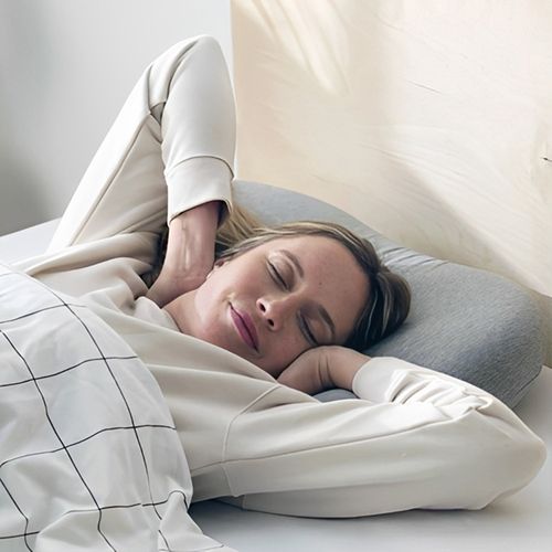 Happy woman sleeping using the bed pillow