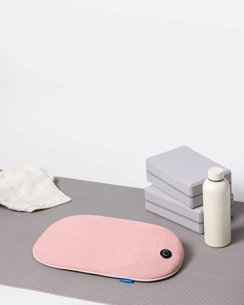 Embrace Heating pad on top of a yoga mat