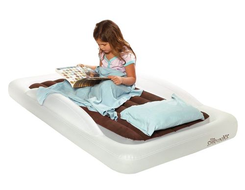 Girl on the Shrunks indoor bed reading a book