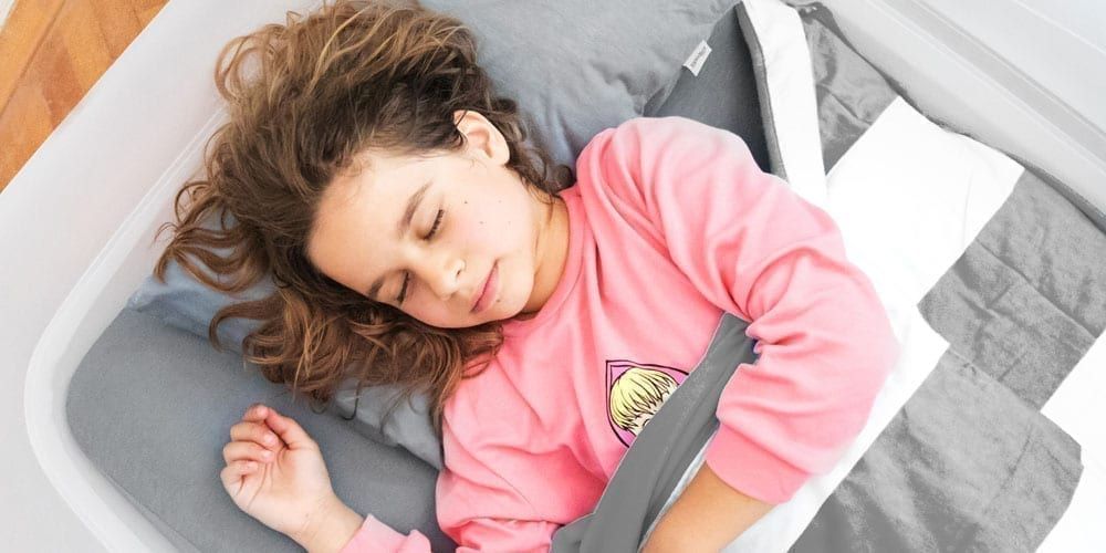 Sleeping kid on the Shrunks bed